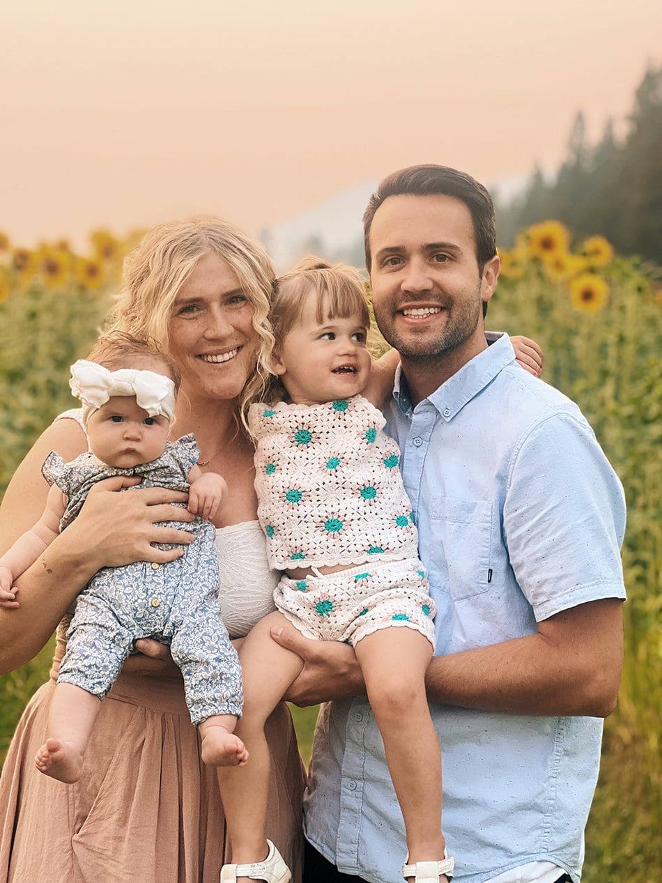 Dentist with his wife and two kids outside on a field